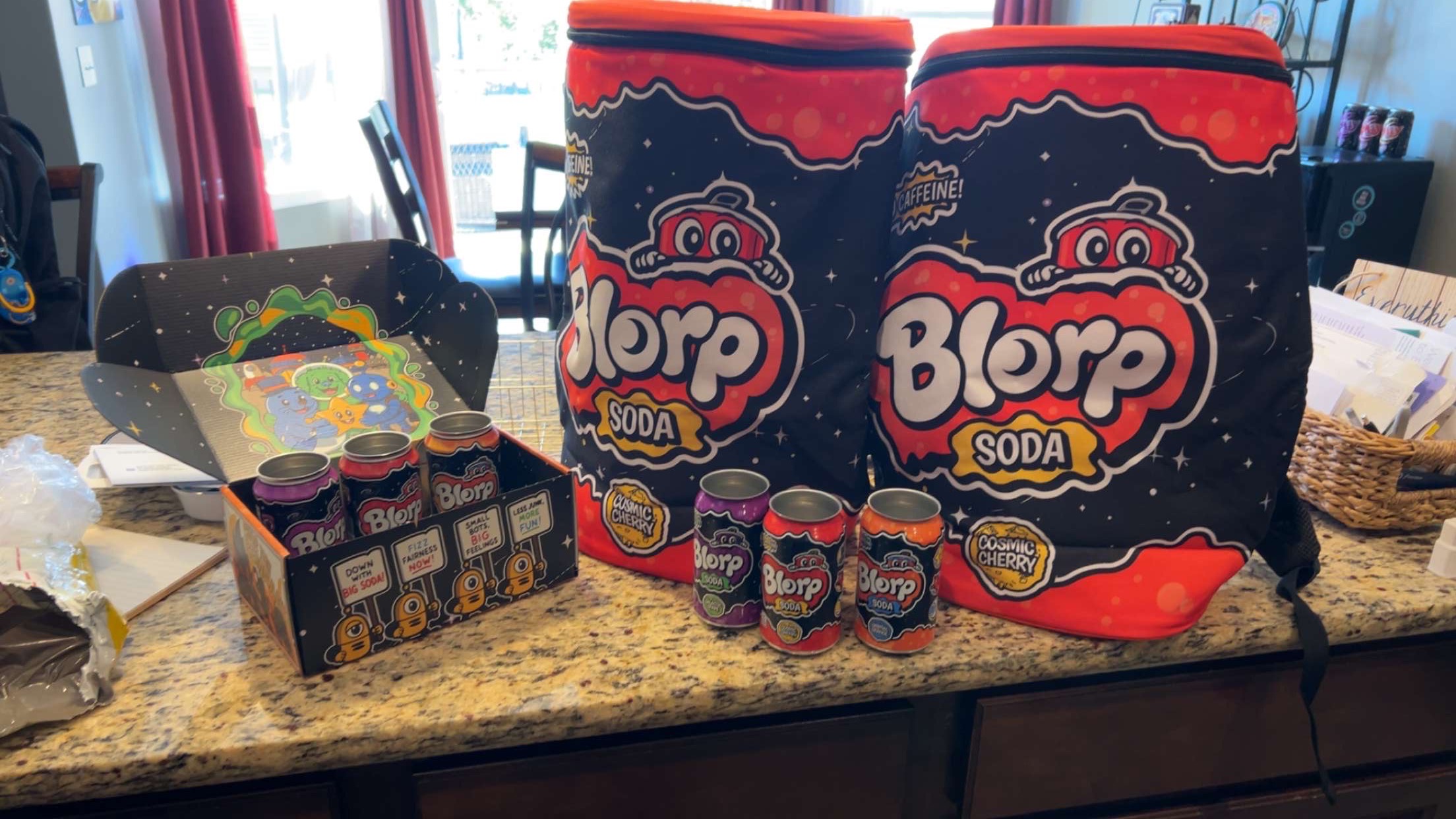 Blorp soda cans, multipack display, and branded coolers prepared for sampling